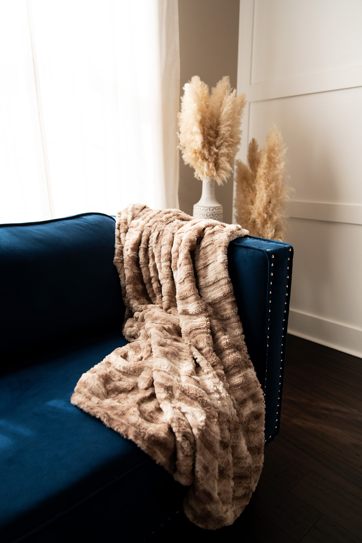 chattanooga boudoir studio with blue sofa, red king size bed, wood floors for an empowering photoshoot